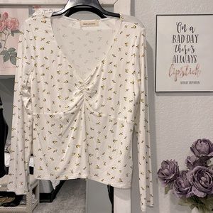 White top with small floral detail